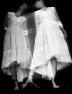 Ghostly double-exposure of a woman in white