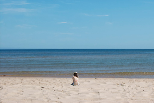The same image edited with Photoshop content-aware filter. Now the person stands in the center of the picture, as the image area was enlarged