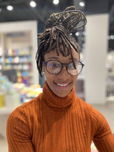 This is an image of Alexandrea Harris-Saunders, a certified personal trainer and mindfulness instructor. Her calm, grounded presence reflects her passion for guiding women of colour through holistic wellness—blending fitness, meditation, and cultural wisdom rooted in her Jamaican heritage.