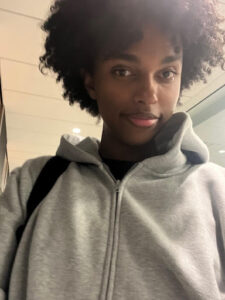 Headshot of Emanuel, a fourth-year Nutrition and Food student at Toronto Metropolitan University, confidently smiling inside a campus building.