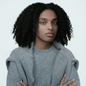 Headshot of Emanuel Tessema looking forward, wearing a grey sweater.