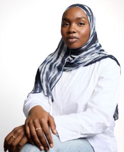 Halima Cherif Hassana, a Black Muslim Registered Dietitian smiling.