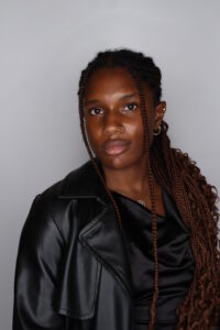 This is an image of Fatoumata Binta Balde, who stands with confidence, reflecting her leadership and commitment to addressing systemic racism in dietetics through research and advocacy.