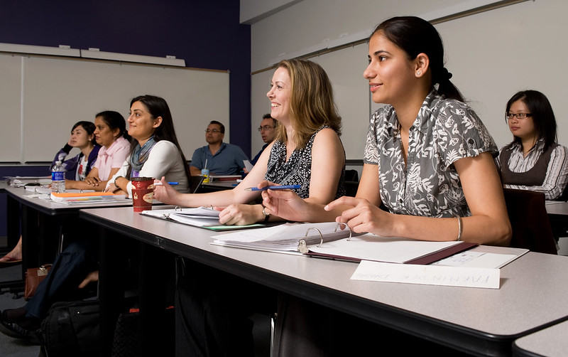 Students sitting at a desk and listening